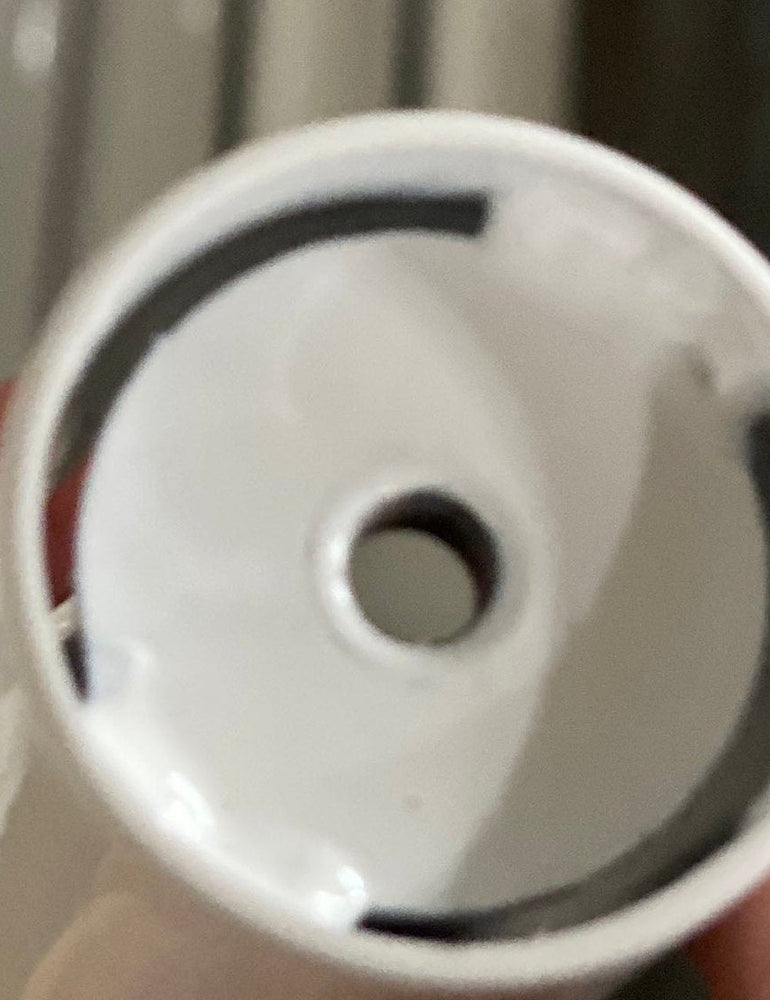 Close view of a new white NoBox post insert seated in the end of a stand tube, held in hand