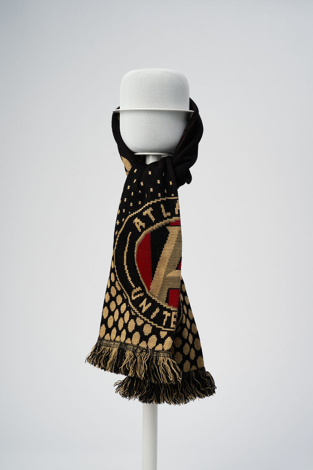 White NoBox HomePod floor stand holding a white Apple HomePod draped with an Atlanta United scarf